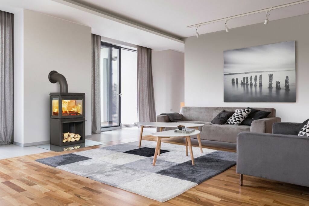 Modern living room with fireplace, sofa, balcony and pattern carpet